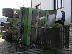 Traktor z przyczepą kukurydzy przewrócił się pod domem. Ładunek zasypał posesję